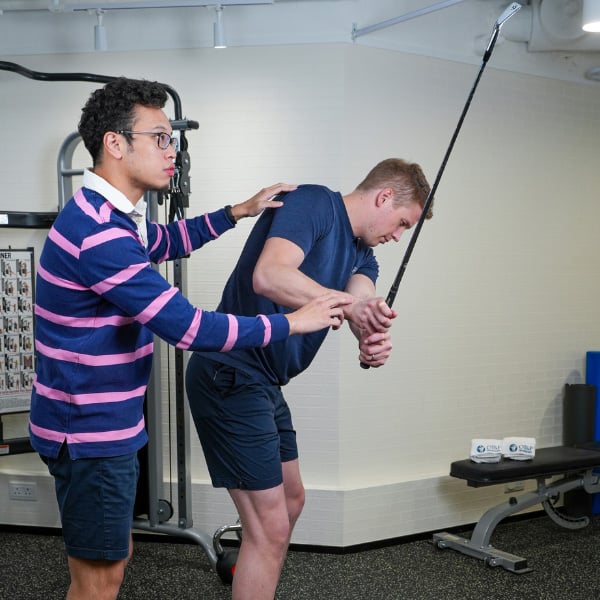 physio analysing golf swing